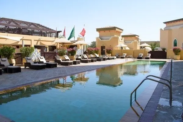 Sunbathe by the pool in the Arabian sun