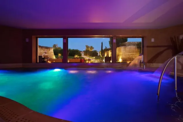 Enjoy lit up garden views from the pool