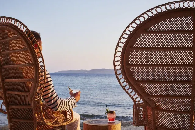 Enjoy a cocktail poolside with sea views